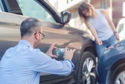 Car Accident Victim Documenting Property Damage