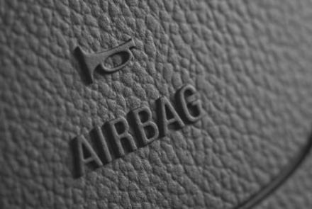 close-up image of steering-wheel with embossed "airbag" sign