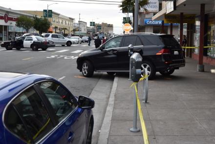 Vehicle Reverses onto Sidewalk Causing Pedestrian Injury